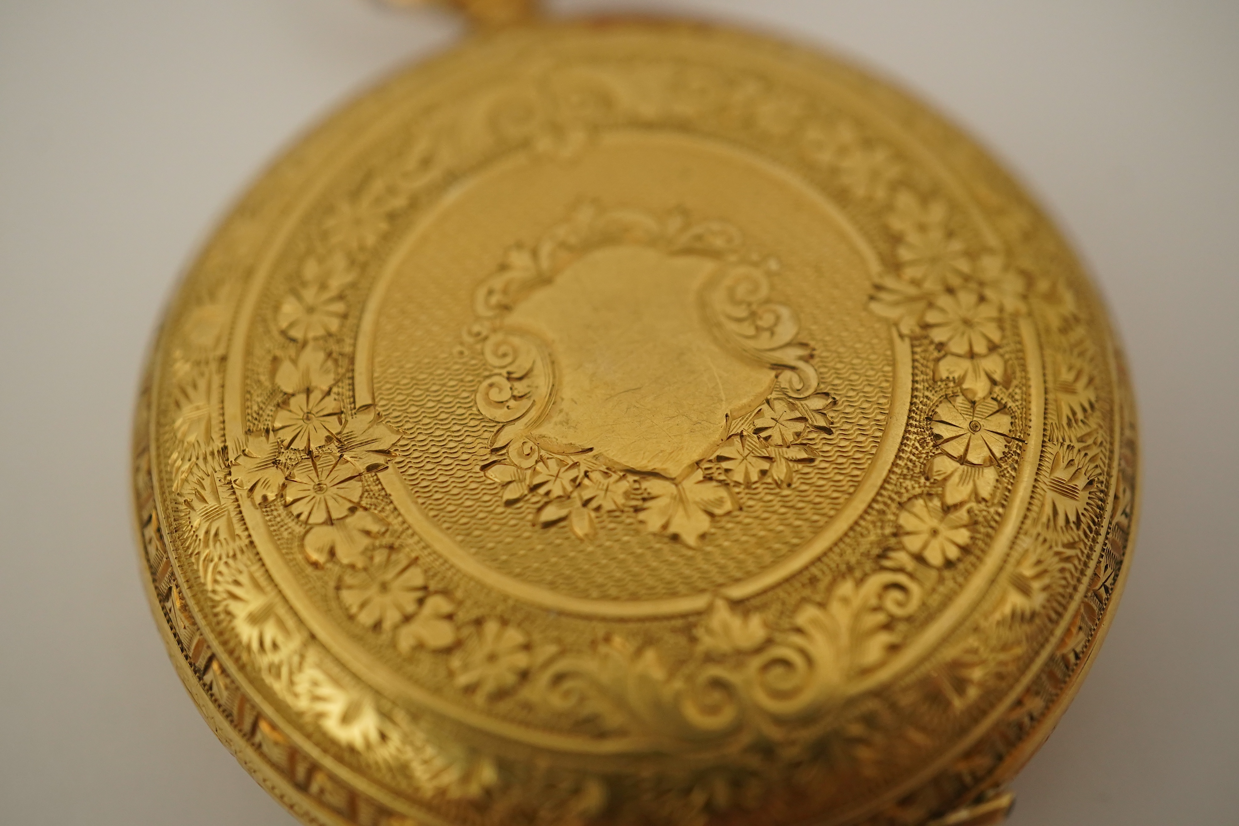 An early 20th century continental engraved 18k gold open faced fob watch